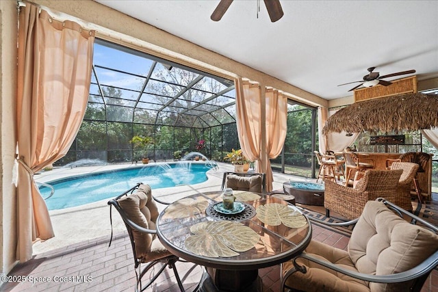 view of patio / terrace with pool water feature, ceiling fan, exterior bar, and glass enclosure