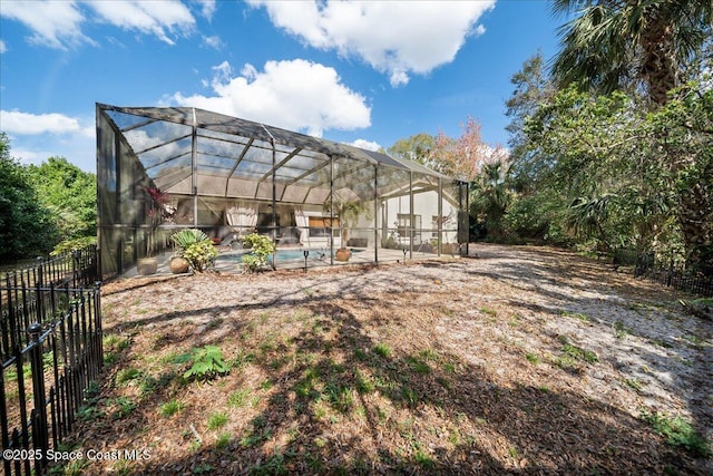 view of yard with a lanai and a fenced in pool