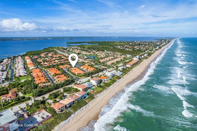 bird's eye view featuring a water view and a beach view