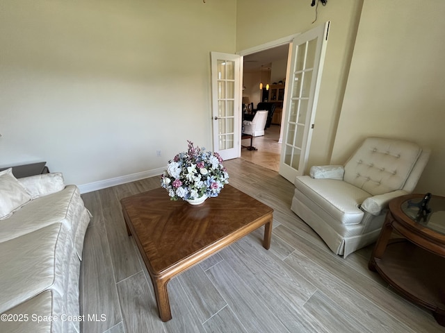 living room with french doors and light hardwood / wood-style flooring