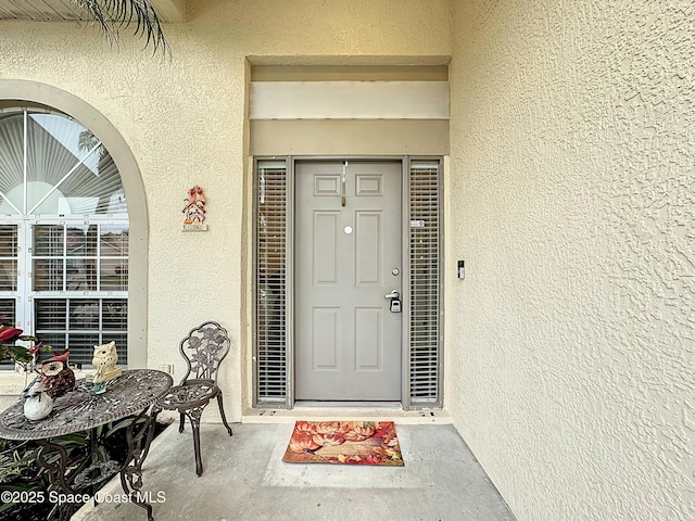 entrance to property with stucco siding