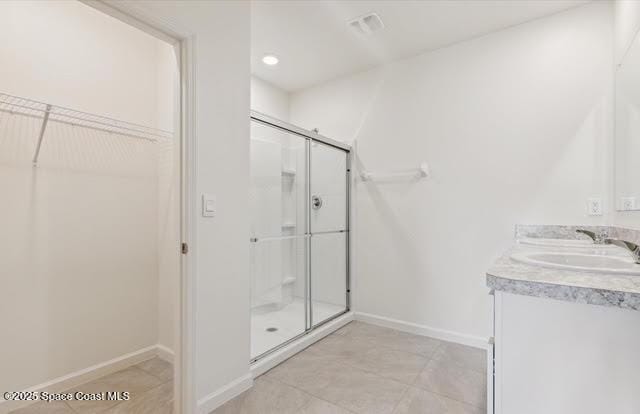 bathroom with vanity and a shower with shower door