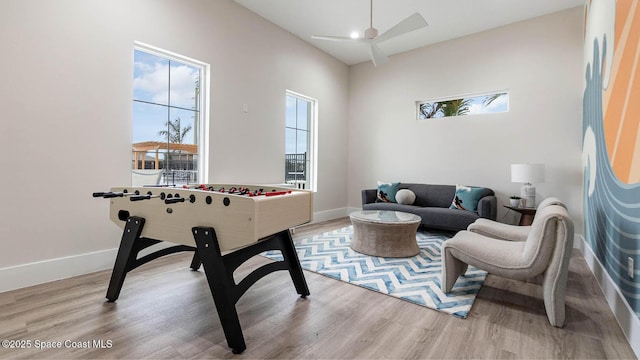 playroom featuring ceiling fan and light hardwood / wood-style flooring