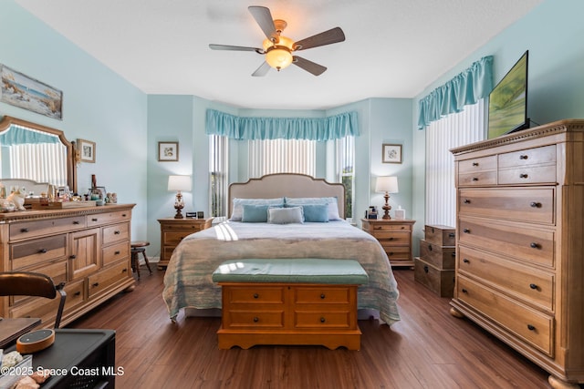 bedroom with dark hardwood / wood-style floors and ceiling fan