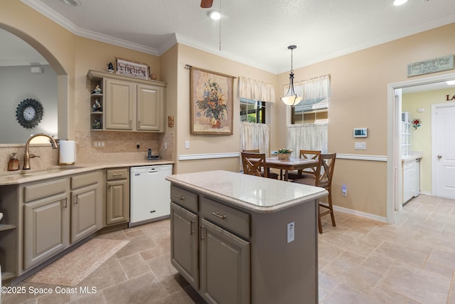 kitchen with sink, a center island, ornamental molding, dishwasher, and backsplash