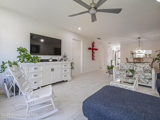 living room with ceiling fan with notable chandelier