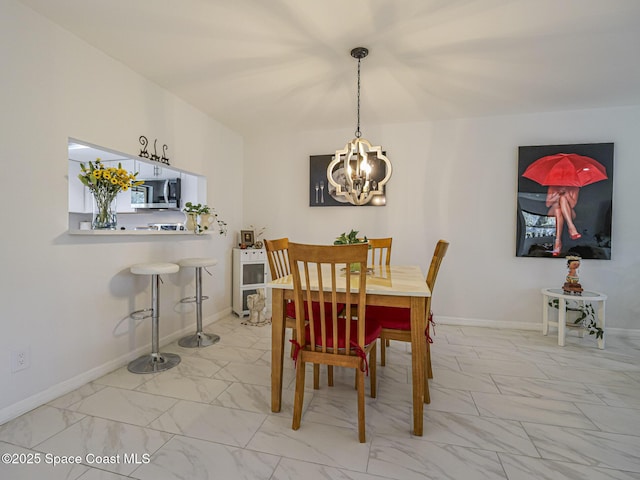 dining area with an inviting chandelier