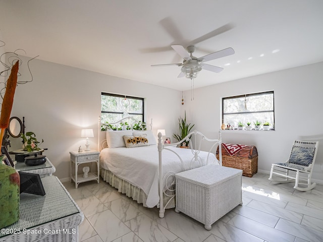 bedroom featuring ceiling fan and multiple windows