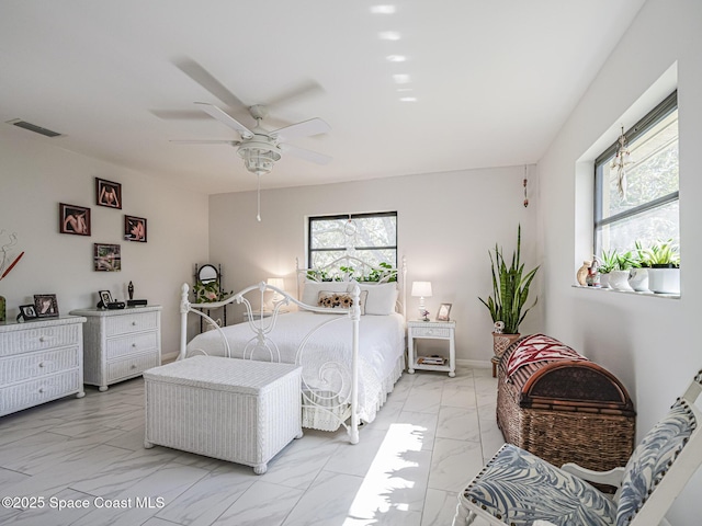 bedroom with multiple windows and ceiling fan