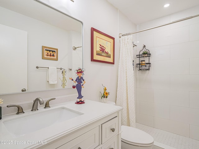 bathroom with walk in shower, vanity, and toilet