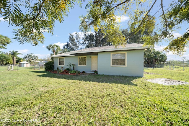 view of front of house with a front lawn and fence