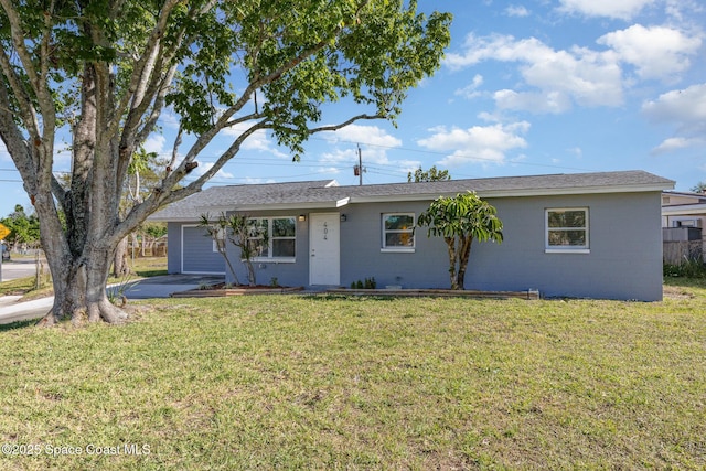 ranch-style home featuring concrete block siding and a front lawn