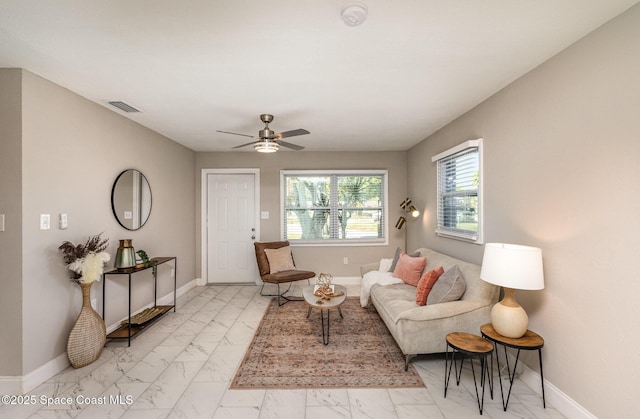 living area with visible vents, baseboards, and marble finish floor