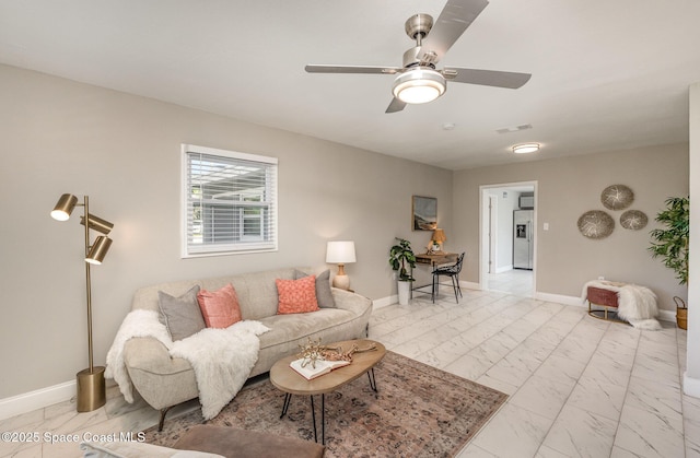 living room featuring visible vents, baseboards, marble finish floor, and ceiling fan