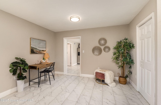 home office featuring marble finish floor and baseboards