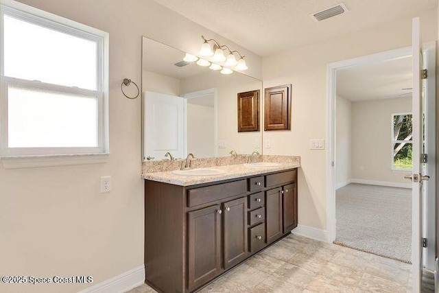 1581 San Filippo Dr SE, Palm Bay, FL 32909 - full bathroom with double vanity and baseboards