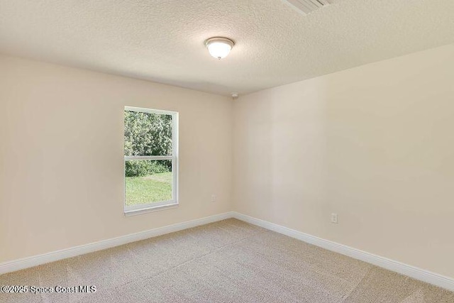 1581 San Filippo Dr SE, Palm Bay, FL 32909 - unfurnished room featuring light colored carpet, a textured ceiling, and baseboards