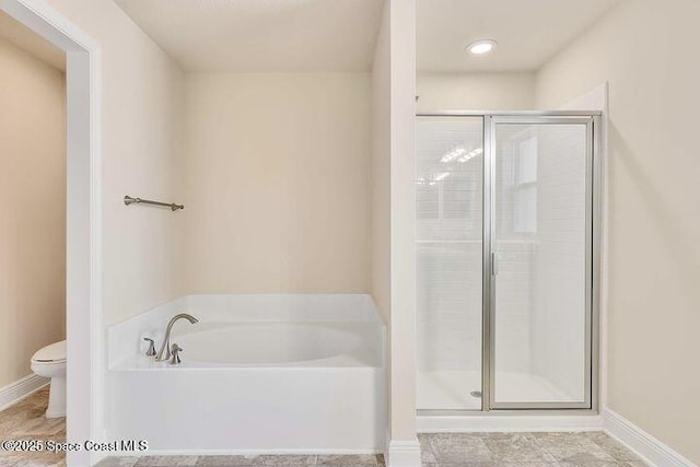1581 San Filippo Dr SE, Palm Bay, FL 32909 - bathroom with toilet, a bath, a stall shower, and baseboards