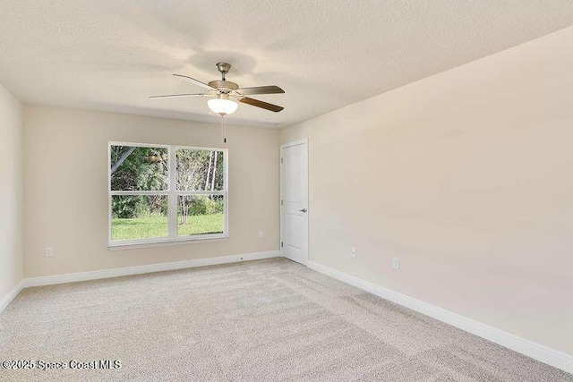 1581 San Filippo Dr SE, Palm Bay, FL 32909 - empty room featuring light carpet, a textured ceiling, baseboards, and a ceiling fan