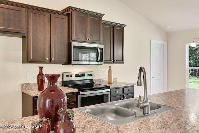 1581 San Filippo Dr SE, Palm Bay, FL 32909 - kitchen with appliances with stainless steel finishes, vaulted ceiling, a sink, and dark brown cabinetry