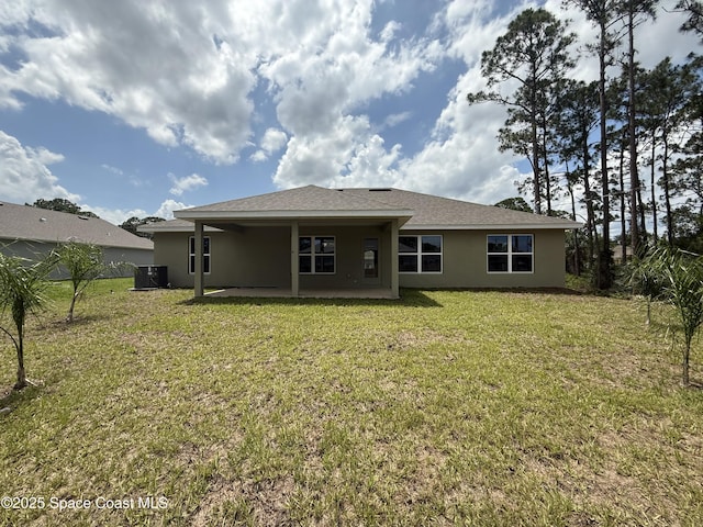 1581 San Filippo Dr SE, Palm Bay, FL 32909 - back of property featuring stucco siding, a patio, and a yard