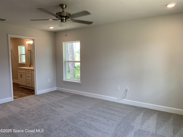 1581 San Filippo Dr SE, Palm Bay, FL 32909 - unfurnished room with dark carpet, ceiling fan, and a textured ceiling