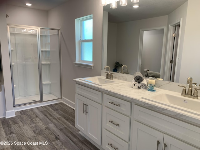 1581 San Filippo Dr SE, Palm Bay, FL 32909 - full bathroom with a shower stall, double vanity, and wood finished floors