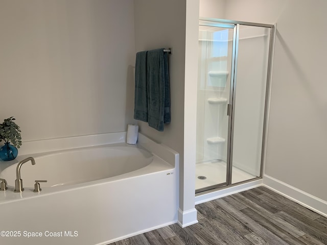 1581 San Filippo Dr SE, Palm Bay, FL 32909 - full bathroom with a shower stall, a bath, and wood finished floors