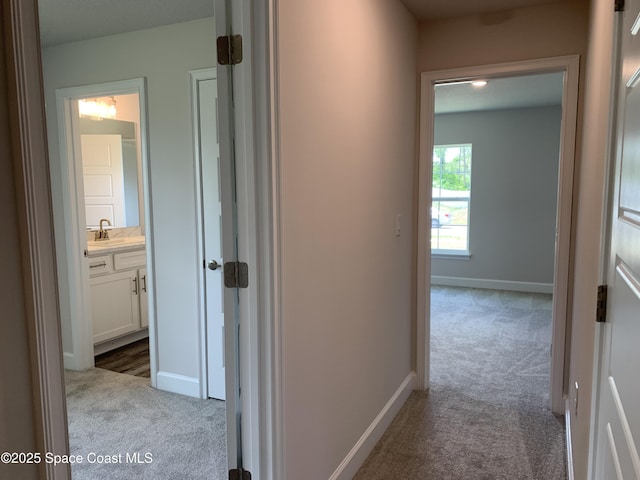 1581 San Filippo Dr SE, Palm Bay, FL 32909 - corridor featuring carpet floors and a sink