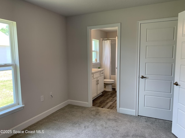 1581 San Filippo Dr SE, Palm Bay, FL 32909 - unfurnished bedroom with carpet flooring and connected bathroom