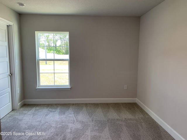 1581 San Filippo Dr SE, Palm Bay, FL 32909 - carpeted empty room with a smoke detector and baseboards