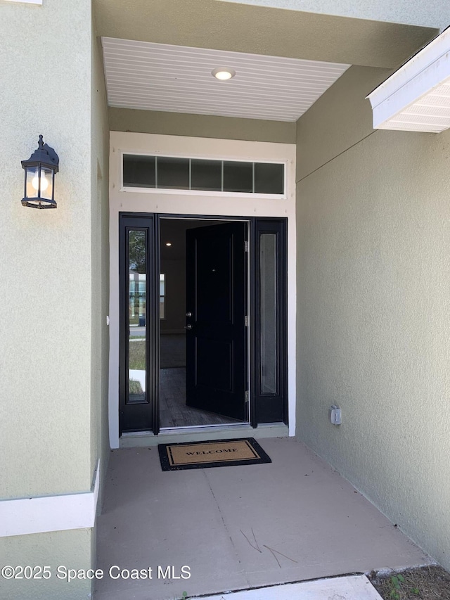 1581 San Filippo Dr SE, Palm Bay, FL 32909 - view of exterior entry featuring stucco siding