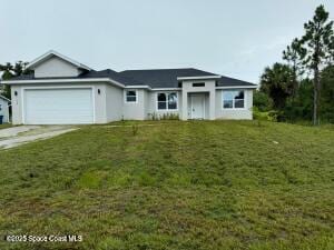 view of front facade with a garage and a front lawn