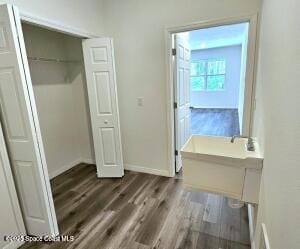 unfurnished bedroom featuring dark hardwood / wood-style flooring and a closet