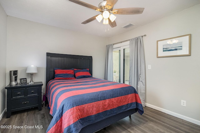 bedroom featuring a ceiling fan, baseboards, visible vents, and wood finished floors