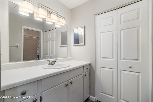 bathroom featuring a closet and vanity