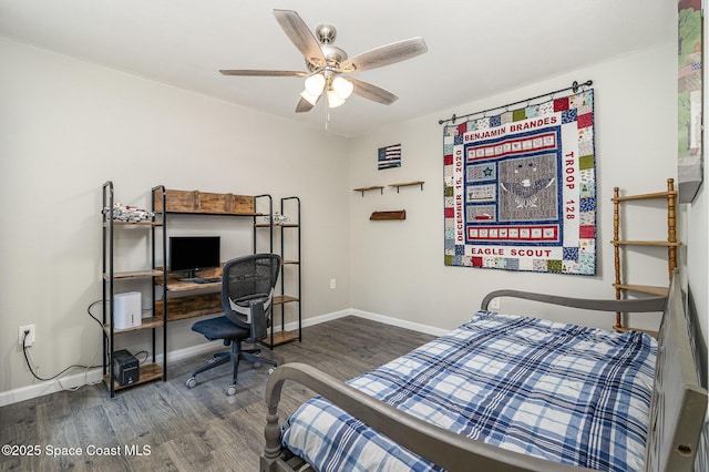 bedroom with a ceiling fan, baseboards, and wood finished floors