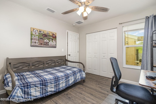 bedroom featuring a ceiling fan, a closet, visible vents, and wood finished floors