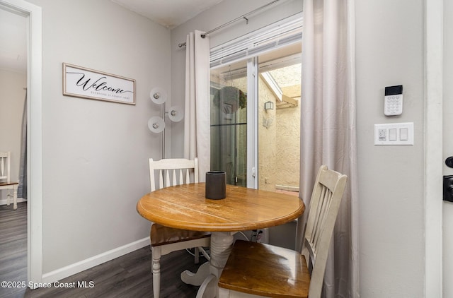 dining room with dark wood-style floors and baseboards