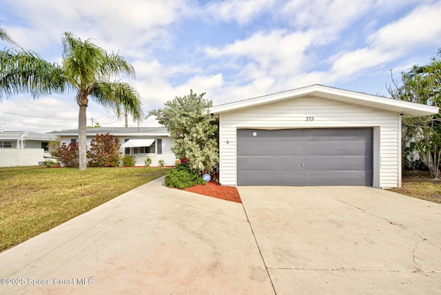 single story home featuring a garage and a front lawn