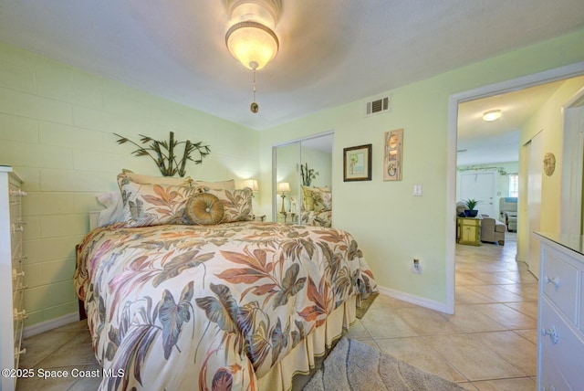 tiled bedroom with a closet