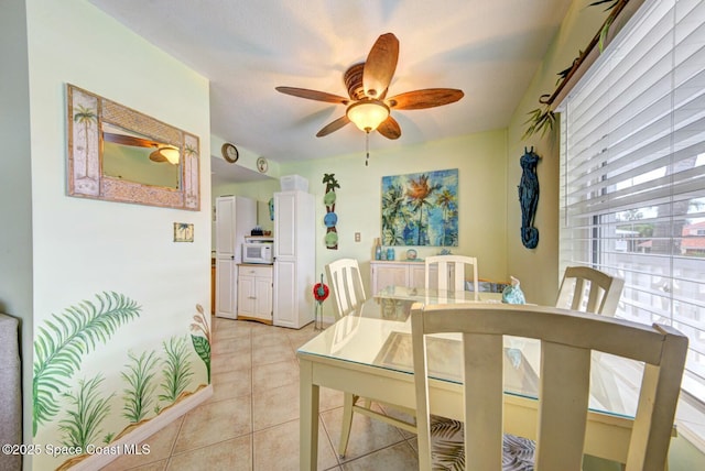 tiled dining room featuring ceiling fan