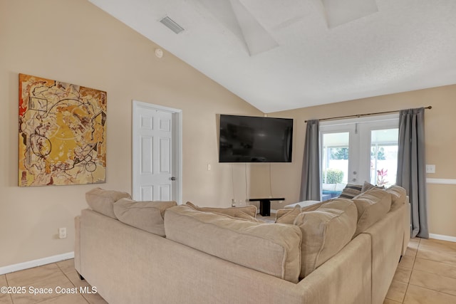 living room with vaulted ceiling, light tile patterned floors, and french doors