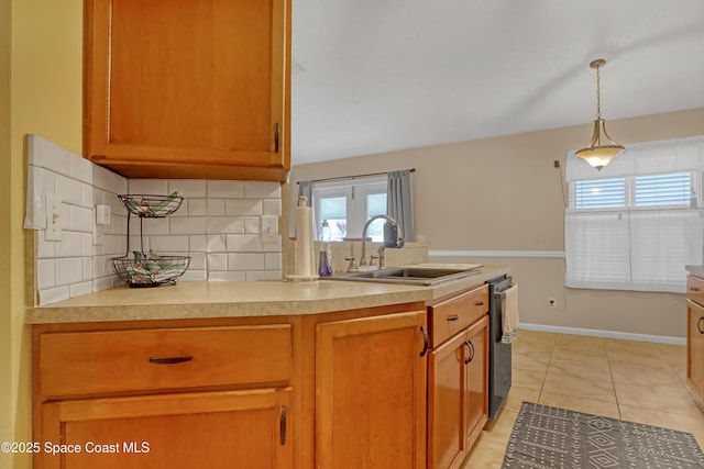 kitchen with sink, light tile patterned floors, dishwasher, hanging light fixtures, and backsplash