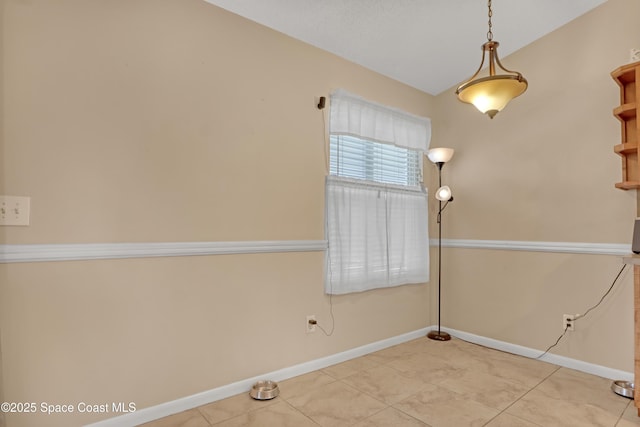 unfurnished room featuring light tile patterned floors and vaulted ceiling