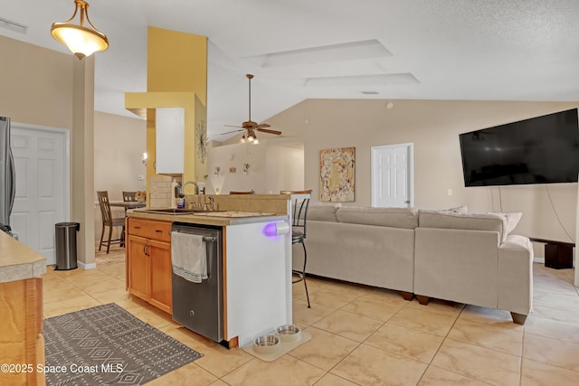 kitchen featuring lofted ceiling, sink, hanging light fixtures, ceiling fan, and stainless steel appliances