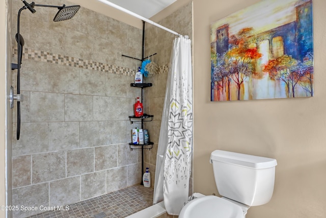 bathroom with a shower with curtain and toilet