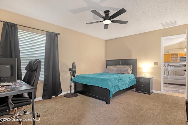 bedroom featuring ceiling fan, carpet, and a textured ceiling