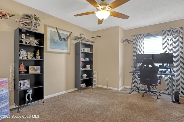 carpeted office with ceiling fan and a textured ceiling