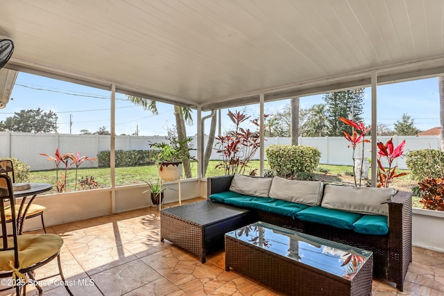 sunroom with wood ceiling and a wealth of natural light